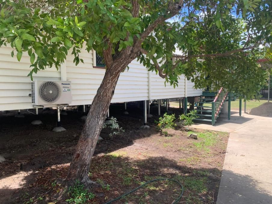 A White House with A Tree in Front of It — Get Stumped Stumping & Maintenance In Bowen, QLD