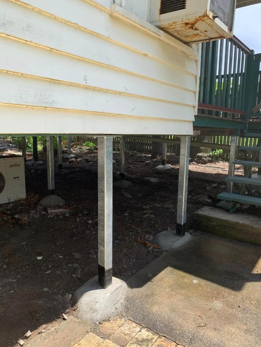 A White House on Stilts with A Green Deck — Get Stumped Stumping & Maintenance In Bowen, QLD