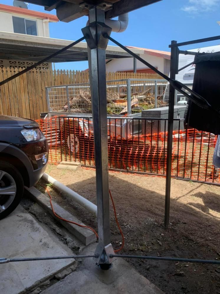 A Car Is Parked in A Driveway Next to A Fence — Get Stumped Stumping & Maintenance In Bowen, QLD