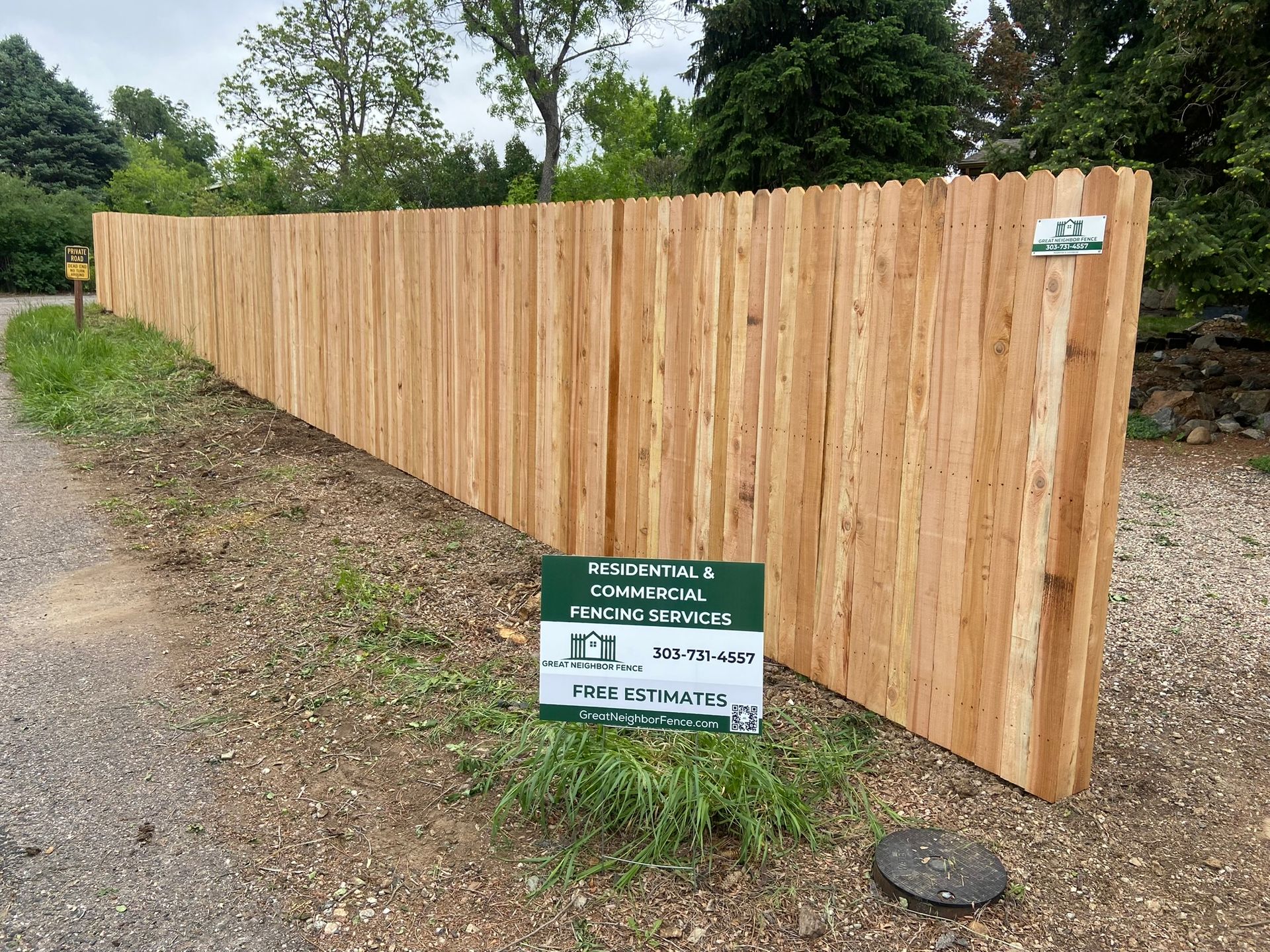 Cedar privacy fence with yard sign 