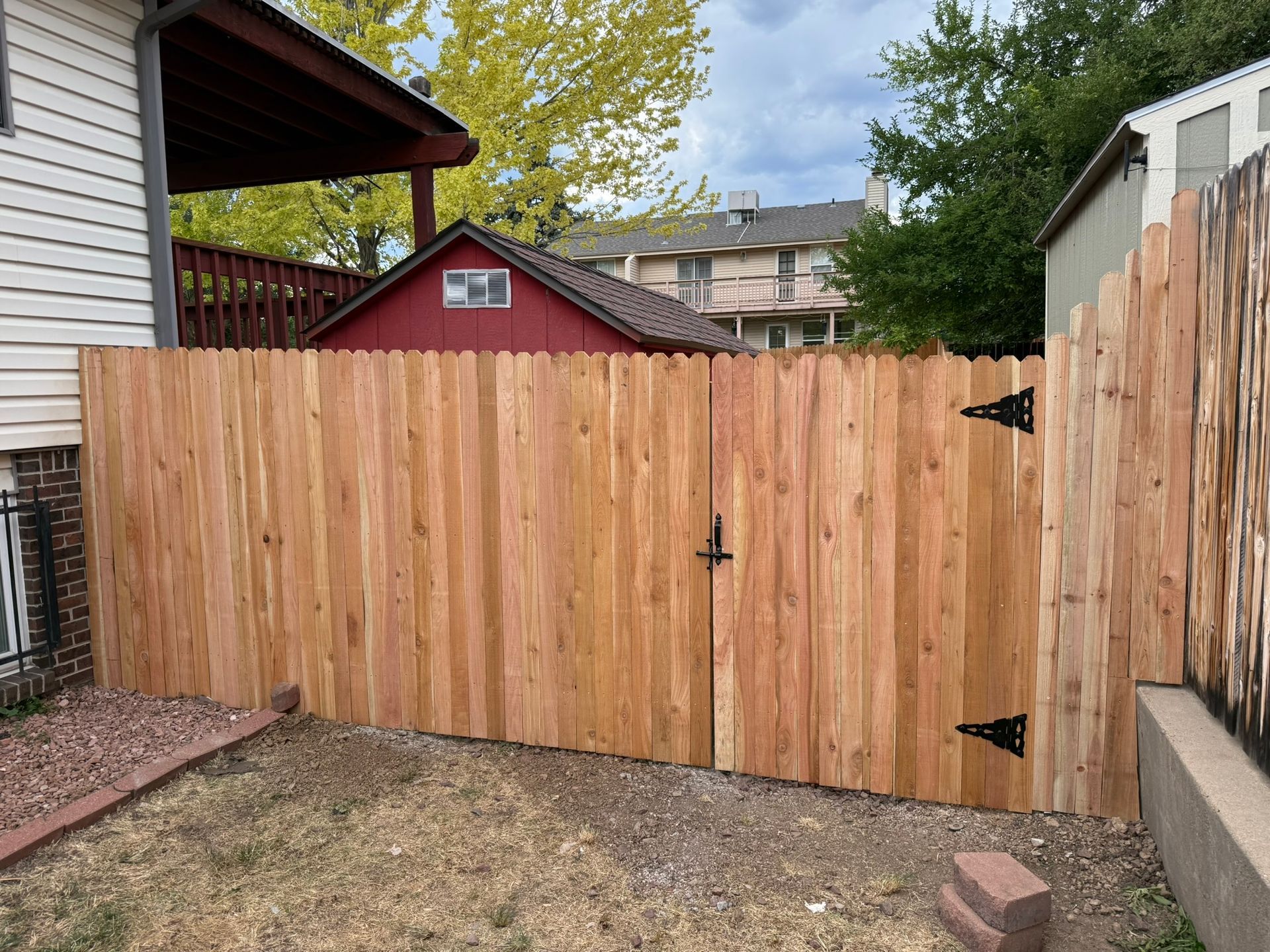 front of gate with barn in background from left side