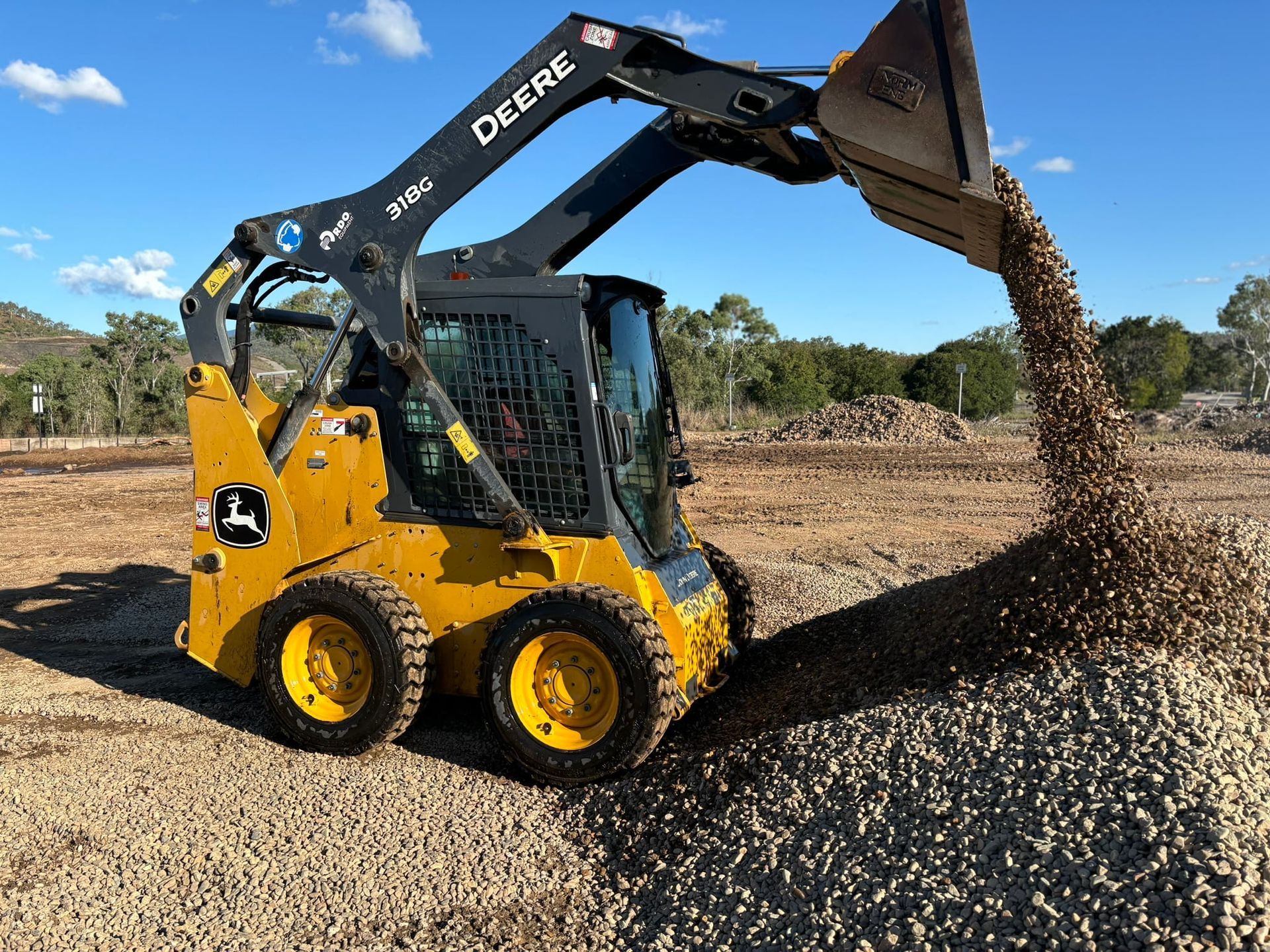 An Excavator Digging Up Gravel — McCahills Earthmoving & Landscaping Supplies In Stuart, QLD
