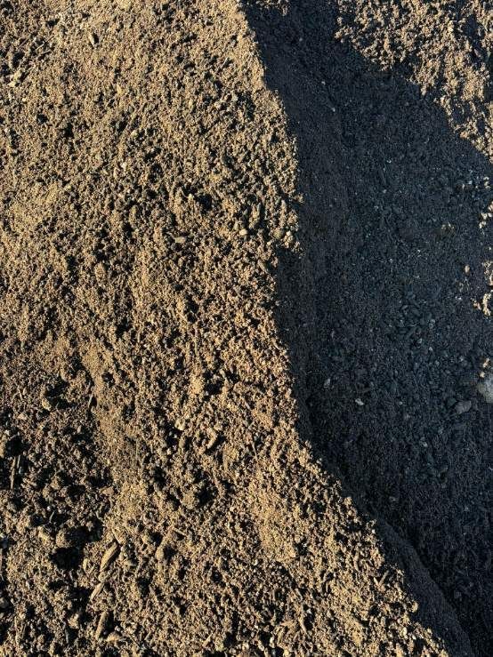 A Pile Of Dirt Is Sitting On Top Of A Pile Of Dirt — McCahills Earthmoving & Landscaping Supplies In Stuart, QLD