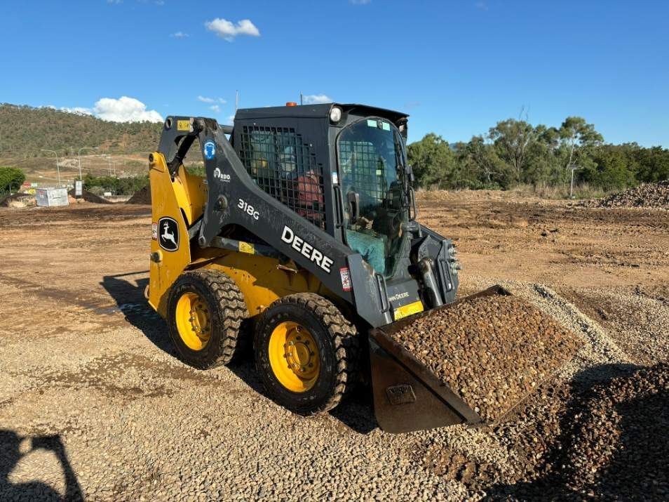 Yellow & Black Skid Steer Loader Is Loading Gravel — McCahills Earthmoving & Landscaping Supplies In Stuart, QLD