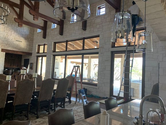 A living room with a table , television , and sliding glass doors.