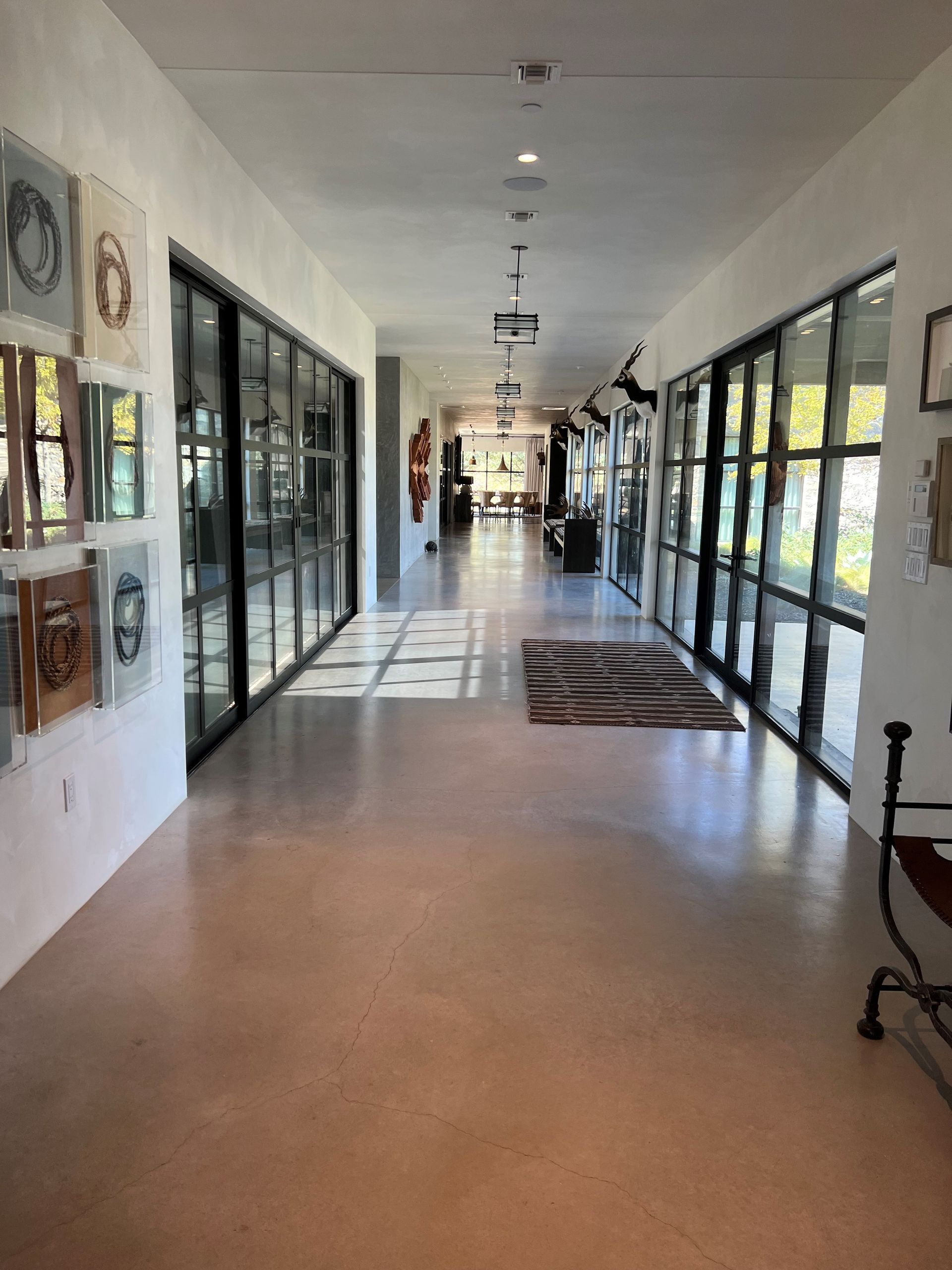A person wearing yellow gloves is cleaning a chandelier.