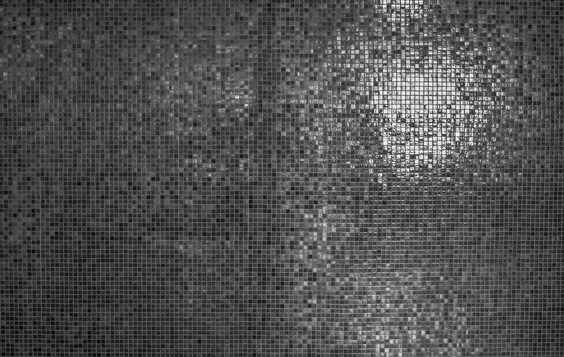 A black and white photo of a mosaic wall.