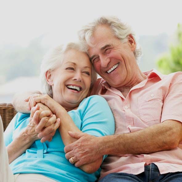 Senior Couple Sitting On Outdoor Seat Together