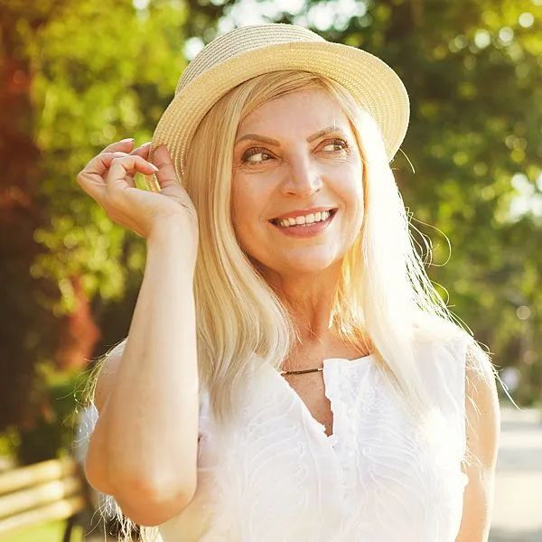 Periodontics - smiling woman with hat