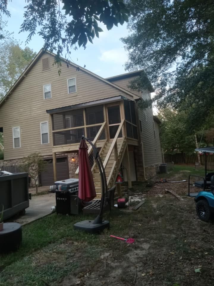 A house with a screened in porch and stairs