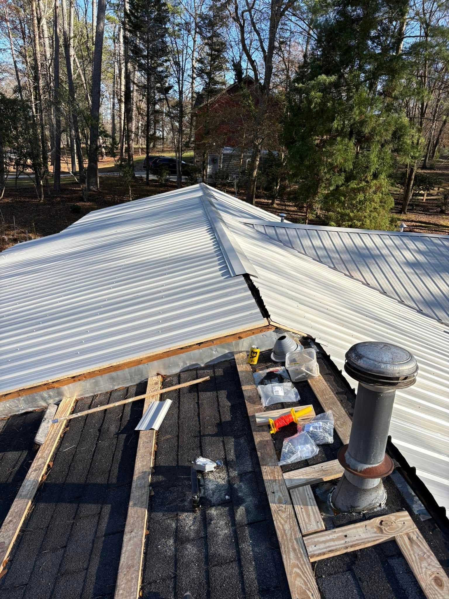 A metal roof is being installed on a house.