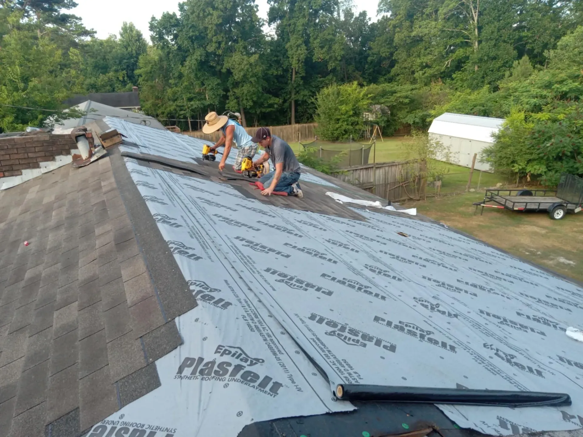 A group of people are working on a roof.