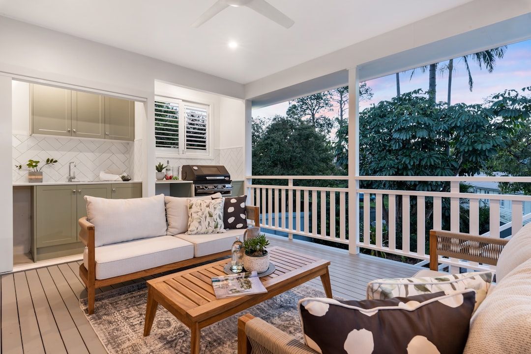 Multi-level wooden deck with furniture and plants.