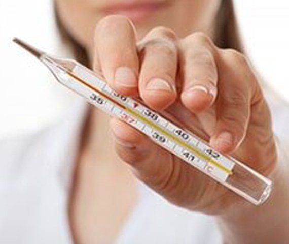 A Nurse Holding A Thermometer | Hampden Medical Group | Englewood, Colorado