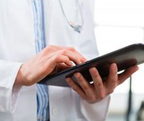 A Doctor Holding A Tablet | Hampden Medical Group | Englewood, Colorado