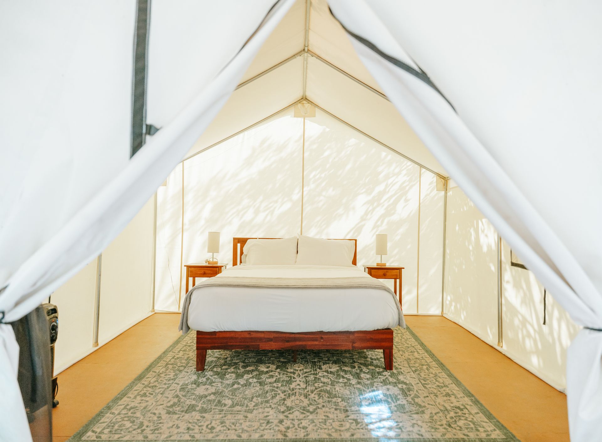 queen bed inside canvas glamping tent