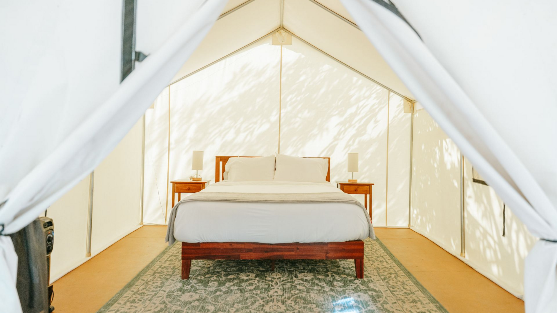 queen bed inside canvas glamping tent