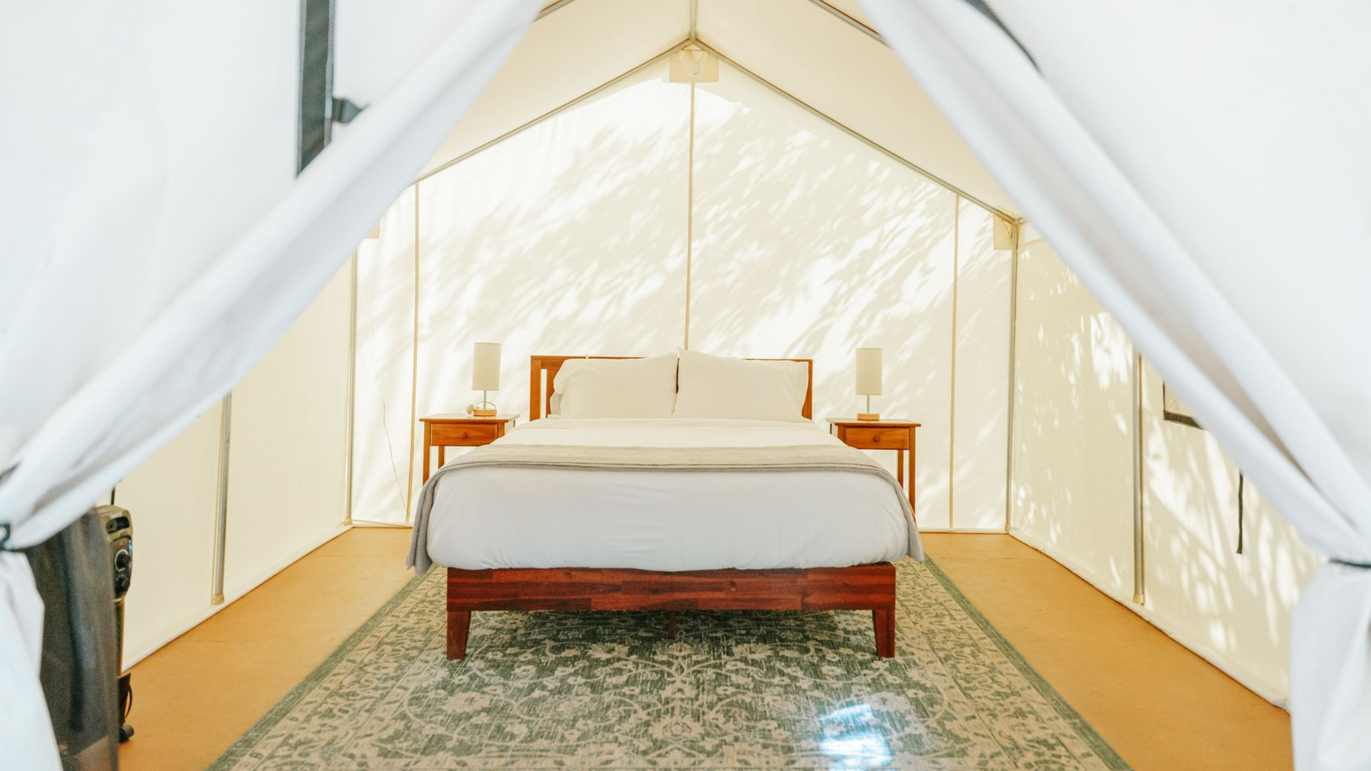 queen bed inside premium canvas glamping tent