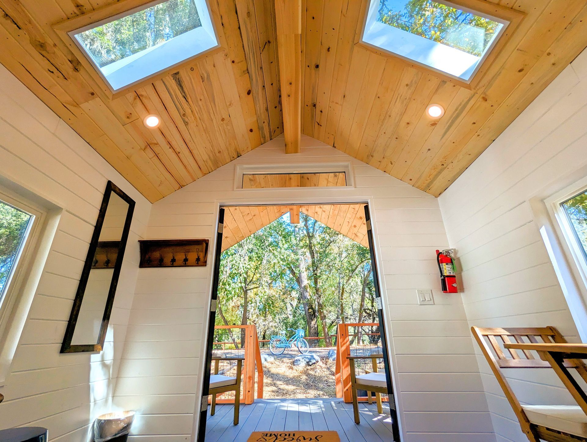 The inside of a tiny house with a skylight on the ceiling.