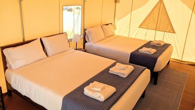 2 queen beds inside premium canvas glamping tent