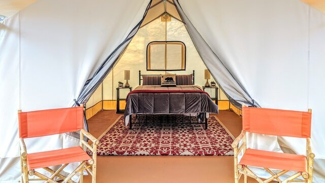 queen bed inside canvas glamping tent