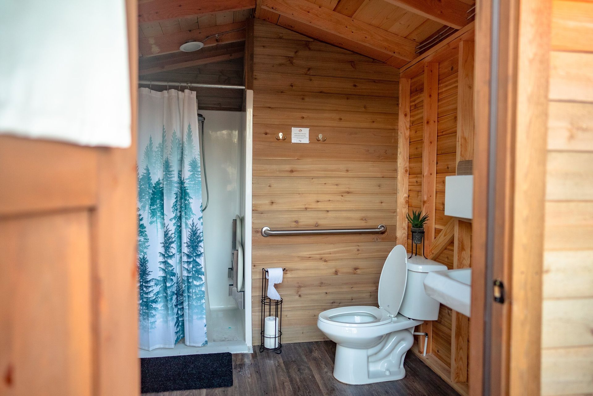 clean cabin-style bathroom with toilet and shower