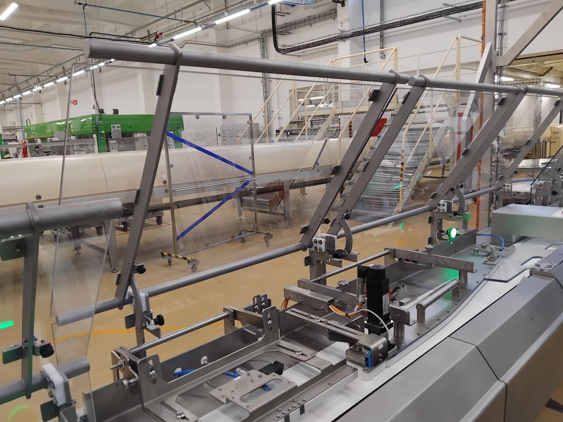 Transparent protective cover for industrial conveyor – reinforced with tempered glass, hinged for easy access.