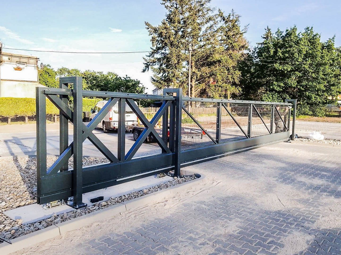 Heavy-duty industrial sliding gate made of galvanized steel, designed for secure access and durability in logistics or warehouse facilities.