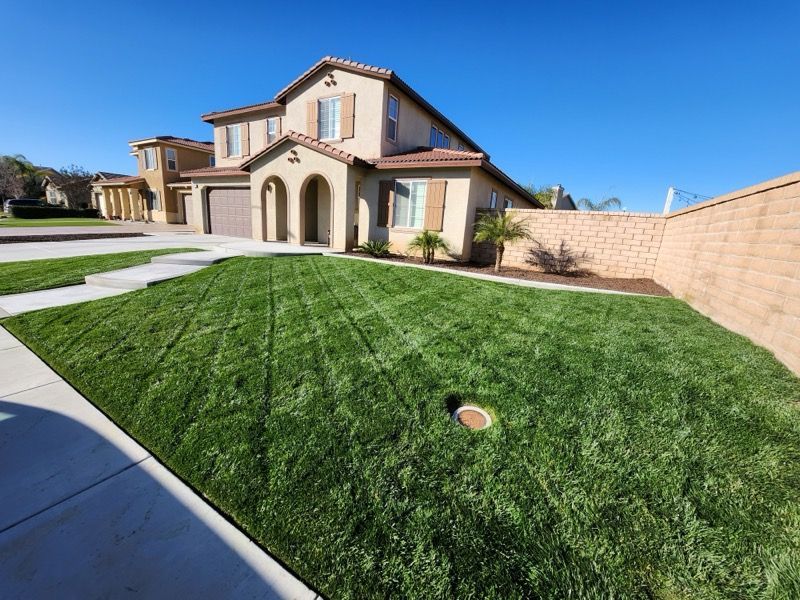 A large house with a lush green lawn in front of it