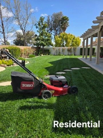 A toro lawn mower is sitting on top of a lush green lawn.