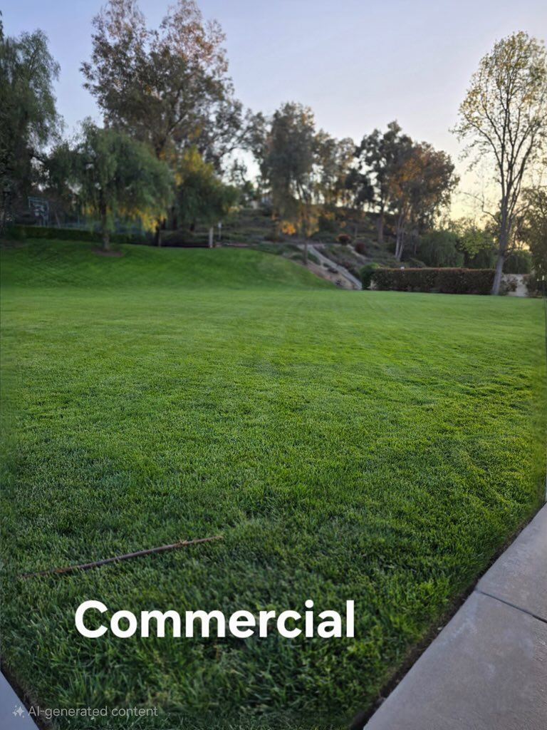 A large lush green lawn with trees in the background and the words commercial on the bottom.