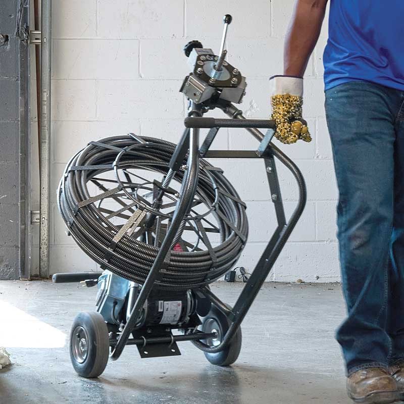 Modern bathroom with white marble-like tile. Includes a shower, toilet, and sink with a mirror.