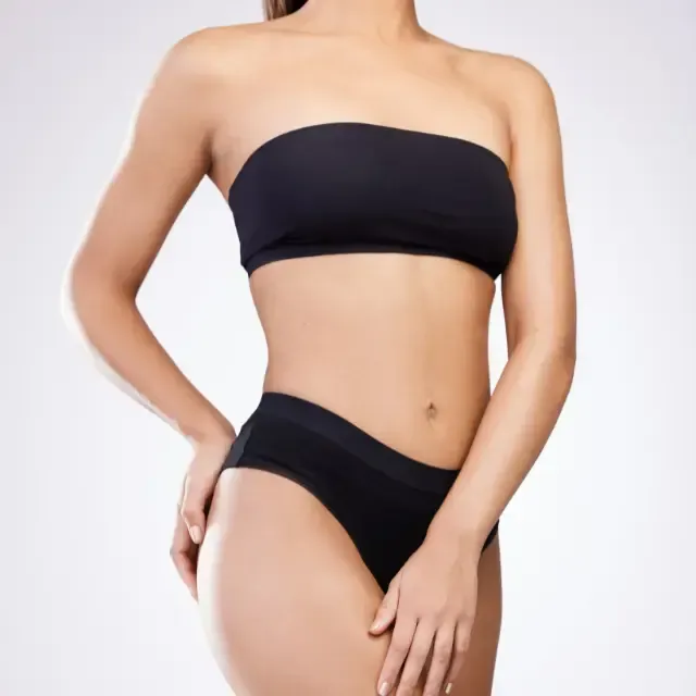 A woman is wearing a black strapless top and black underwear