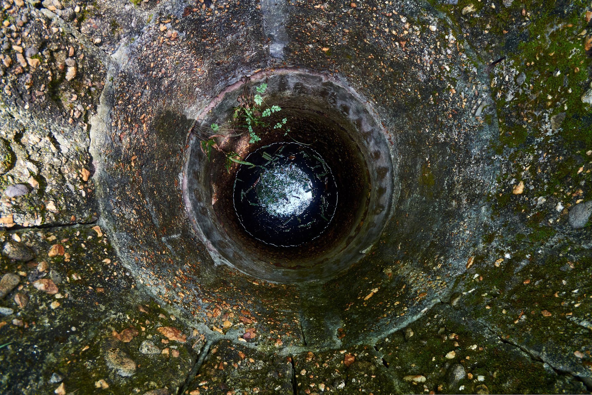 A big bottomless hole in the ground with groundwater.