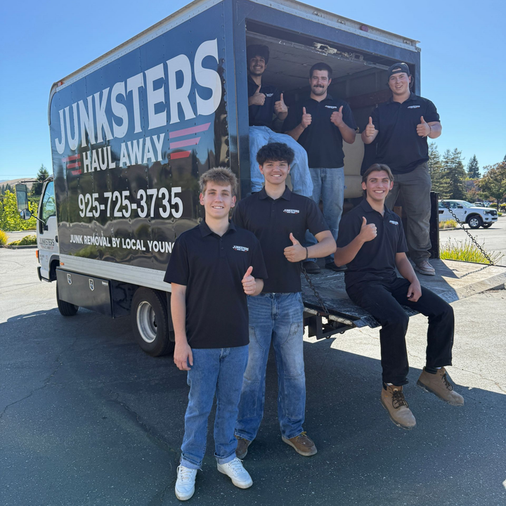 A group of men are posing for a picture in a truck