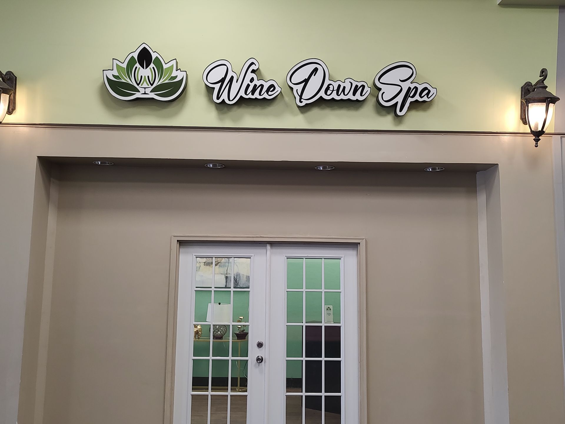 The outside of a spa with a sign that says wine down spa