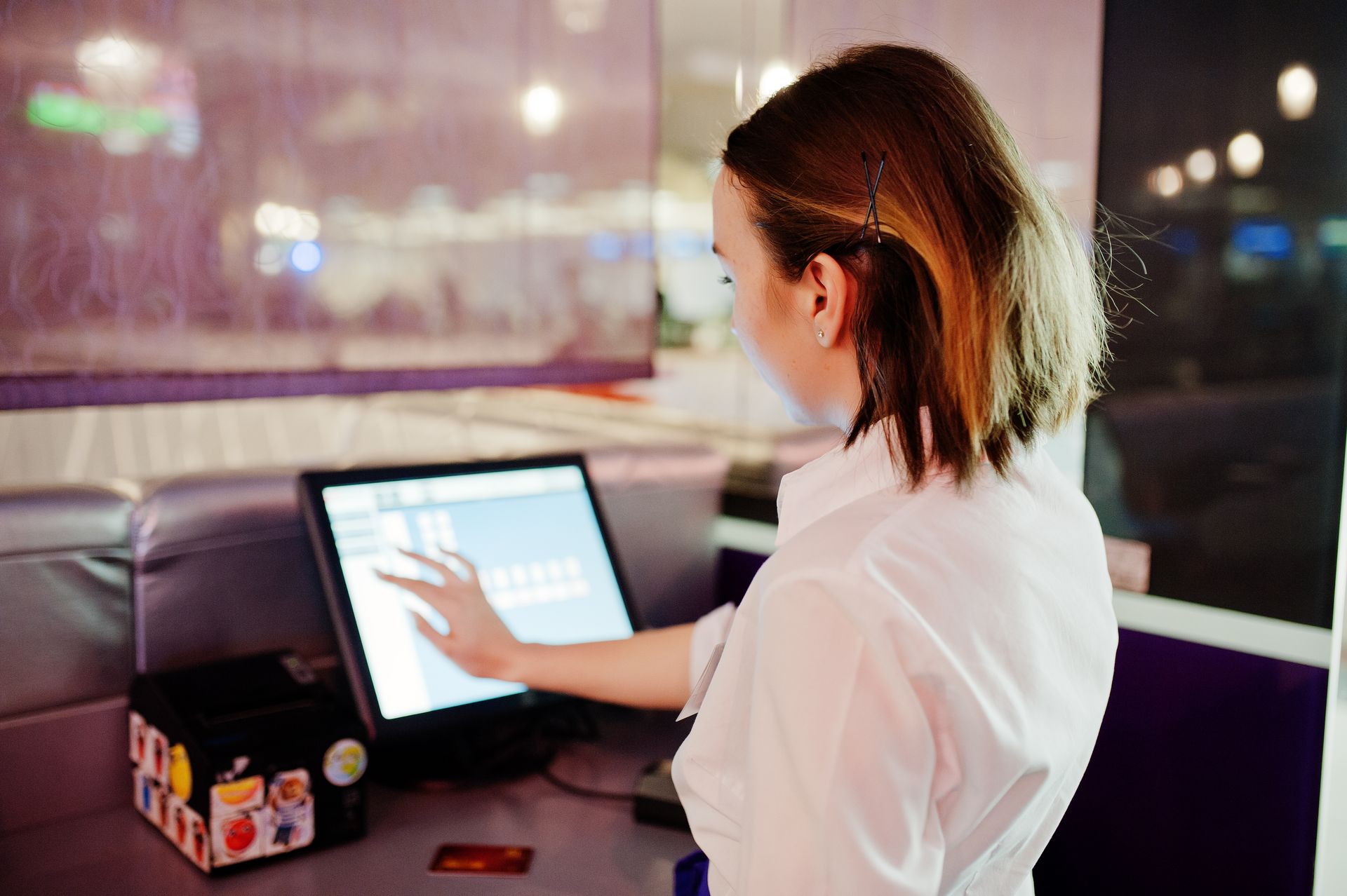 A waiter working with a POS terminal at a restaurant. A waiter working with a POS terminal at a restaurant.