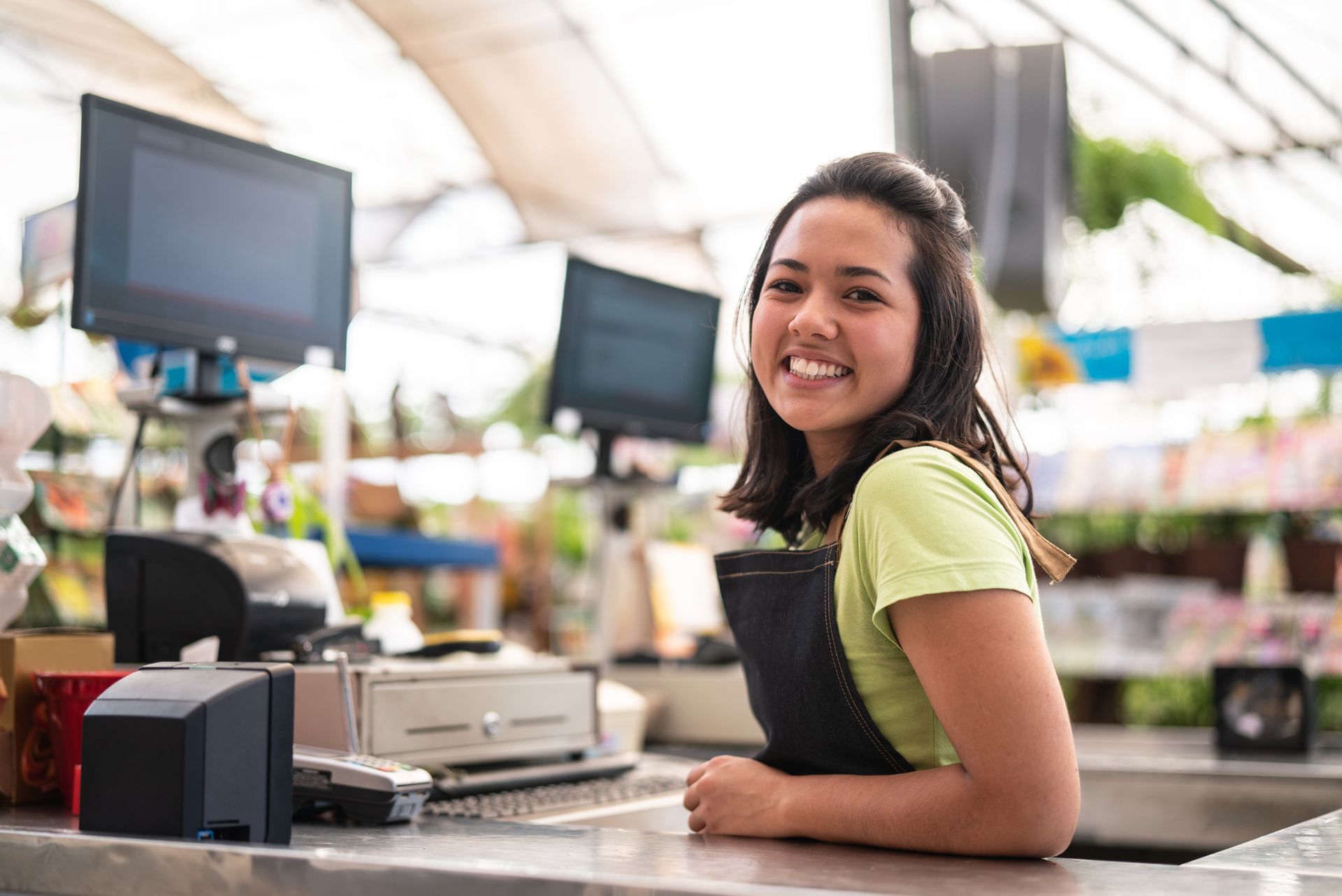A woman uses a POS hardware system.
