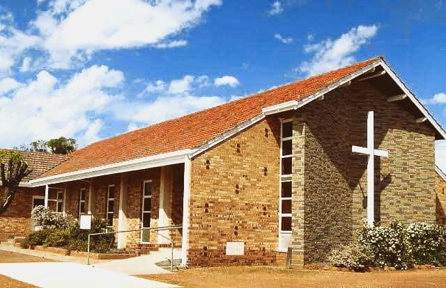 A church with a cross on the side of it