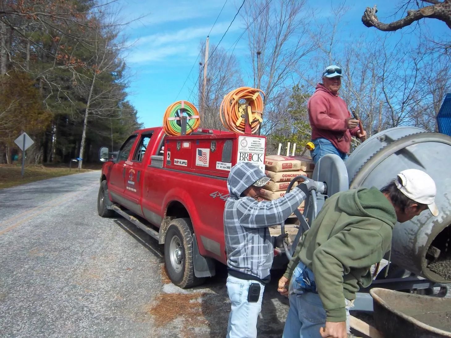A red truck is parked on the side of the road.