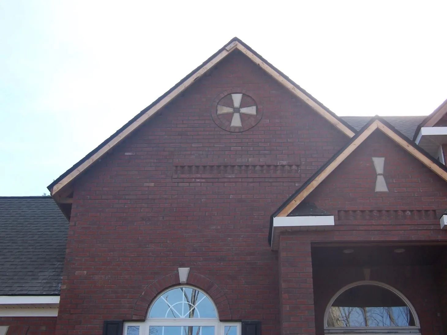 A brick building with a cross.