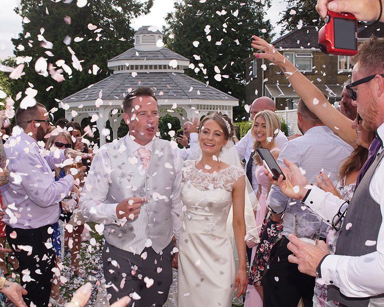 Bride and Groom with confetti at outdoor wedding in Ilminster, Somerset