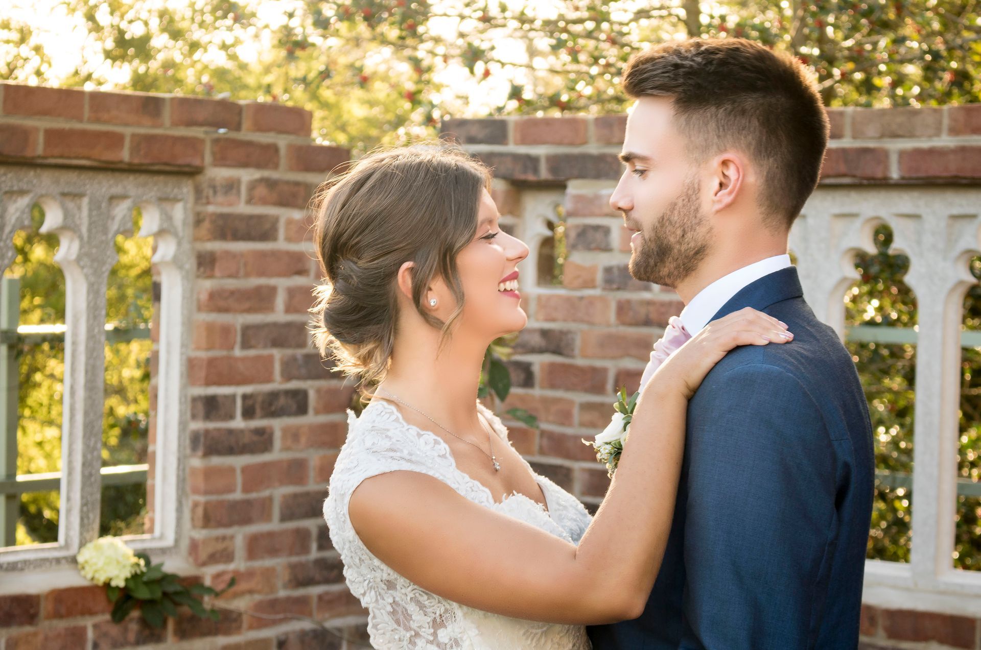 Couple posing in front of the wedding folly wall in Ilminster, Somerset