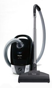 Black Miele canister vacuum cleaner.