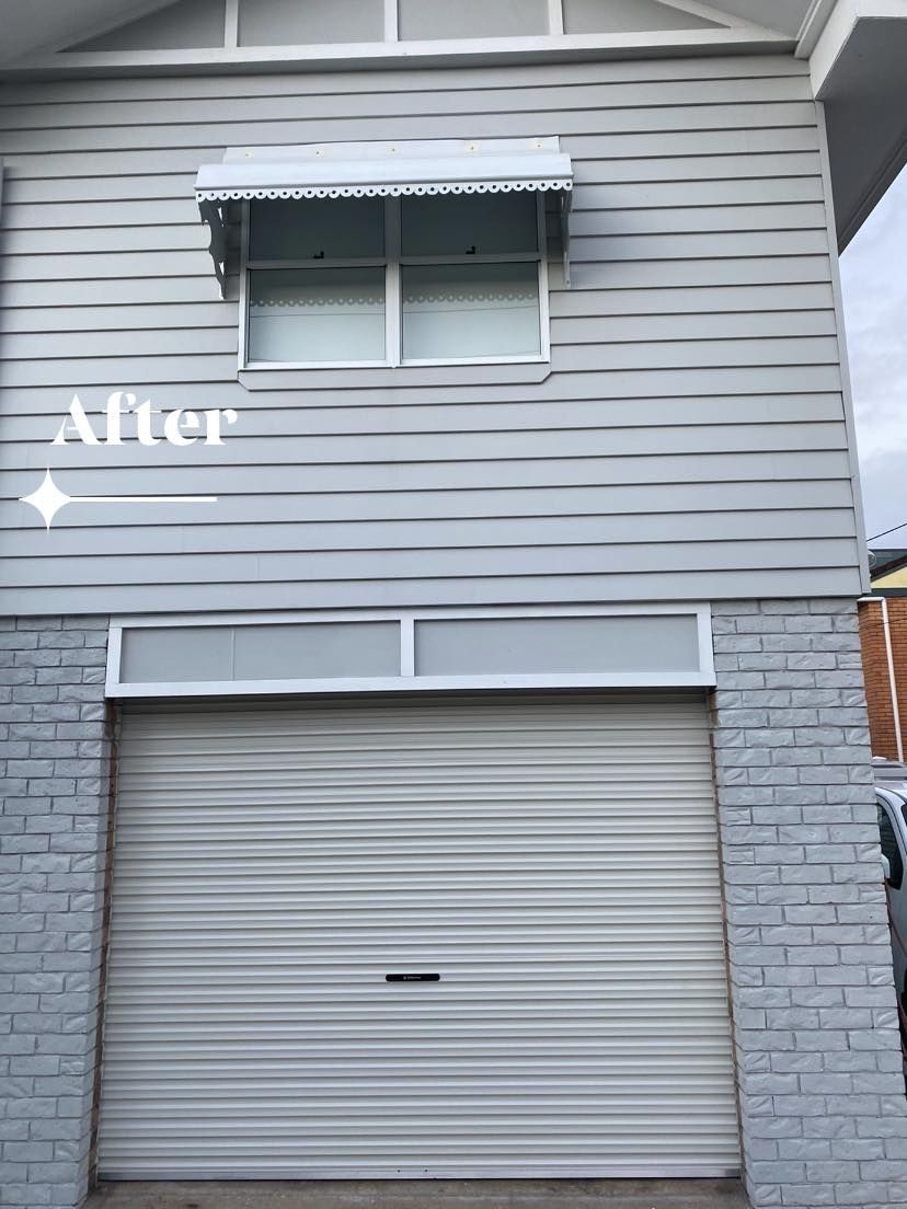 A building with a garage door and a window.