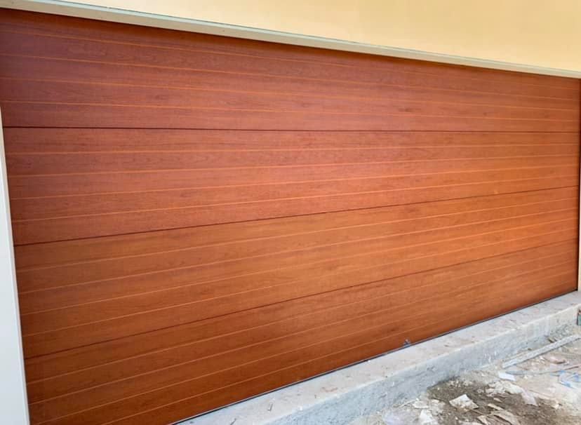 A close up of a wooden garage door on a house.