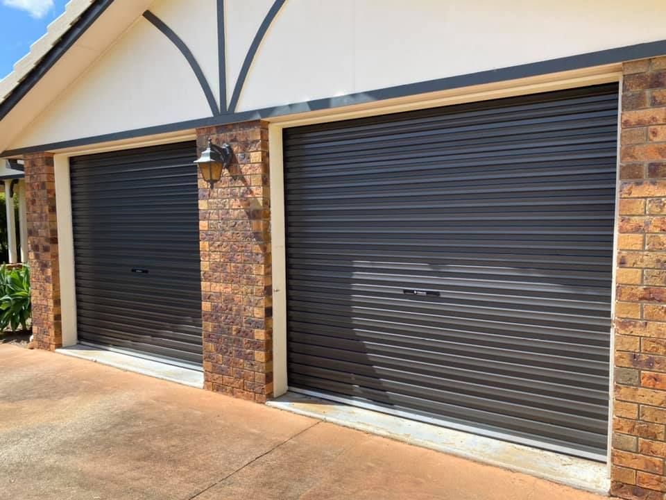 A couple of garage doors on the side of a house.