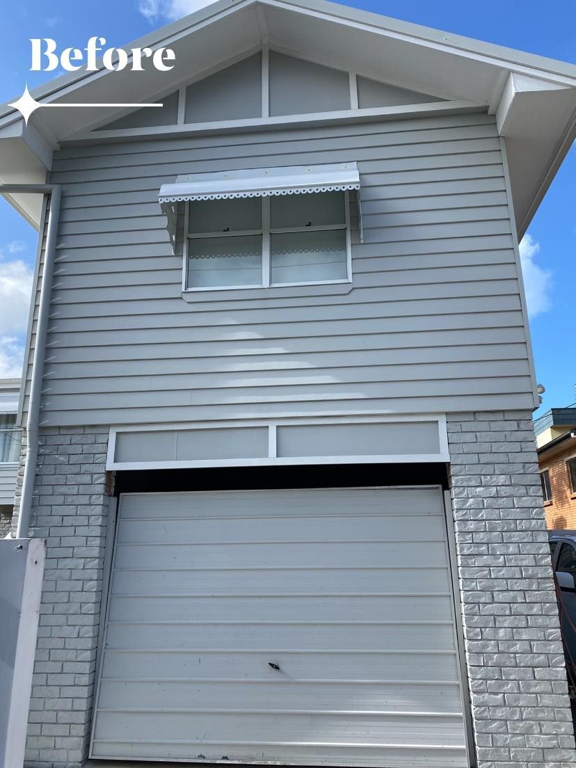 A before picture of a house with a white garage door