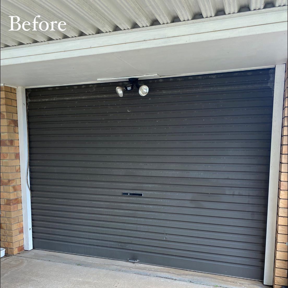 A picture of a garage door before being painted.