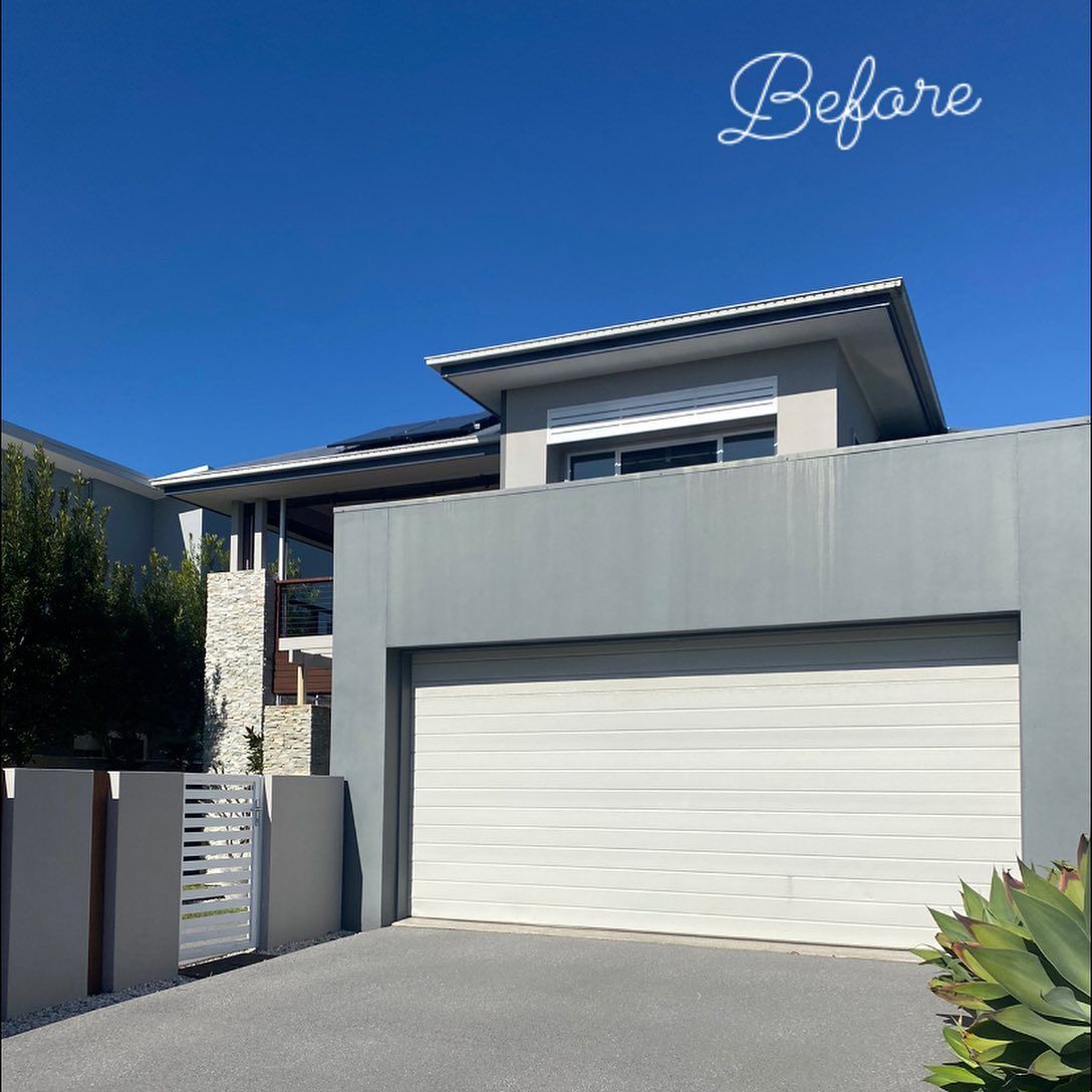 A before picture of a house with a white garage door